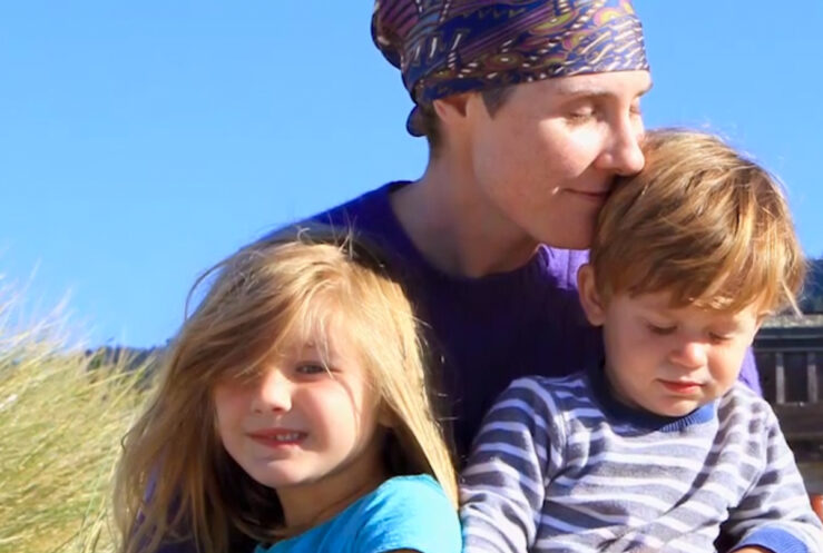 Laura shares a moment in the sun at the beach with her two children